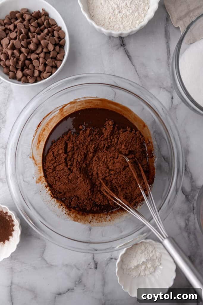 Cocoa powder in a bowl full of melted chocolate