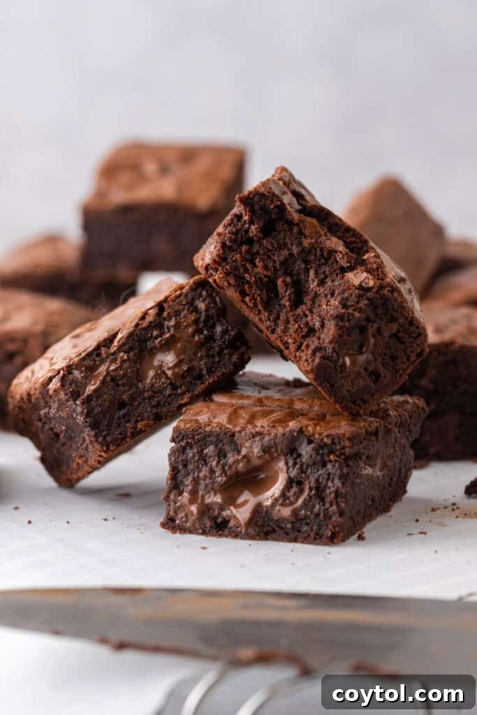 Fudgy Brown Butter Brownies stacked on top of each other, showcasing their rich color and texture