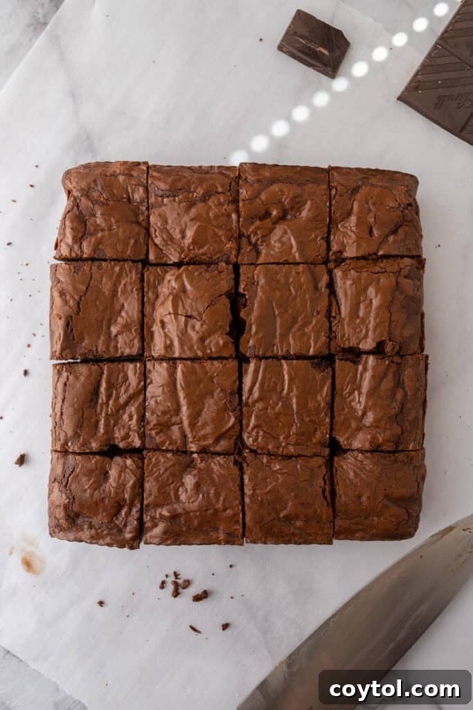 Perfectly sliced fudgy brownies on a cutting board