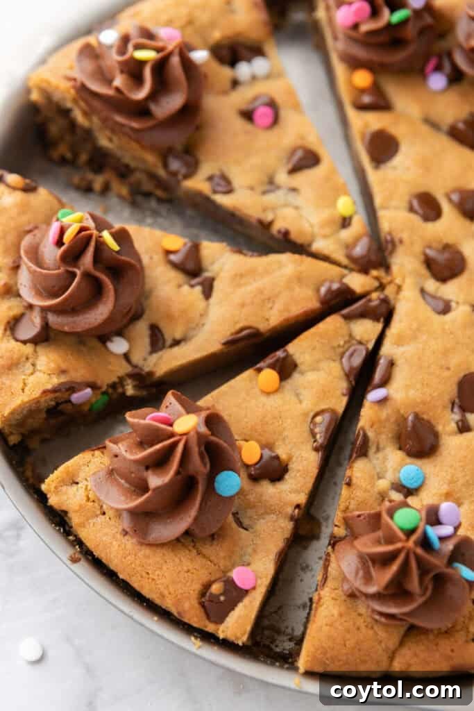 The Ultimate Homemade Chocolate Chip Cookie Cake 14 Another overhead shot of the fully baked and frosted chocolate chip cookie cake, garnished with sprinkles.