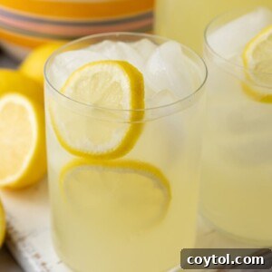 A glass of homemade lemonade with lemon slices and ice