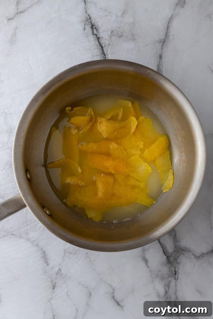 Lemon simple syrup being stirred in a saucepan