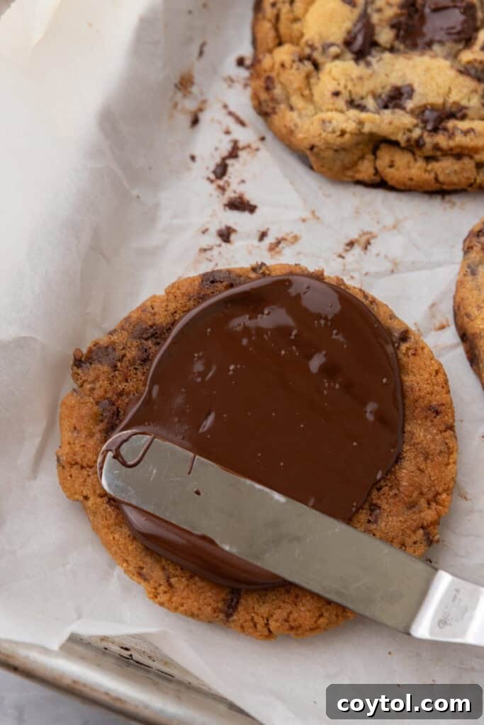 The Ultimate Jacques Torres Inspired Chocolate Chip Cookies 14 baked product getting a spread applied