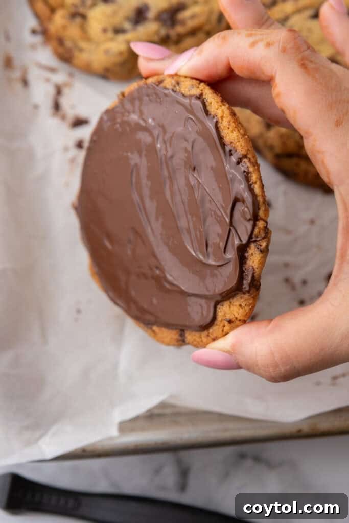 The Ultimate Jacques Torres Inspired Chocolate Chip Cookies 15 baked product getting a spread applied