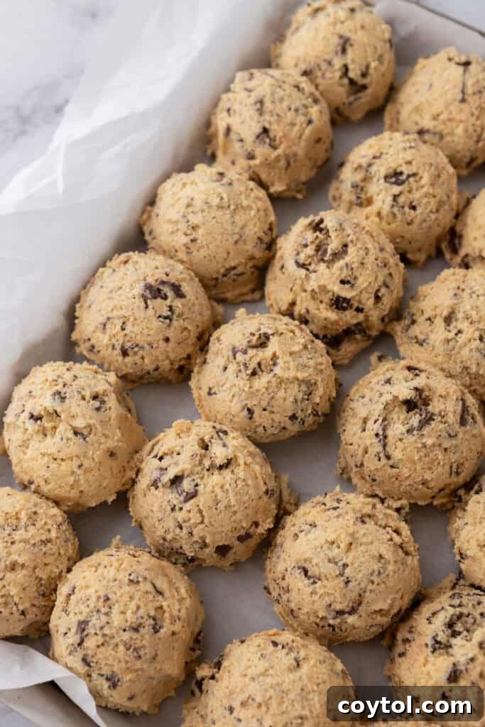 The Ultimate Jacques Torres Inspired Chocolate Chip Cookies 10 dough balls chilling on a baking sheet