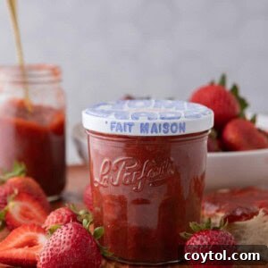 A jar of homemade strawberry rhubarb jam, perfect for a recipe card.