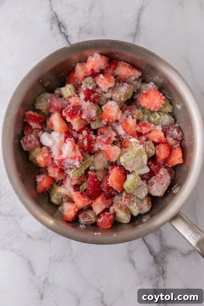 Homemade Strawberry Rhubarb Jam Without Pectin 6 Fruit and sugar in a pot after maceration, showing released juices.