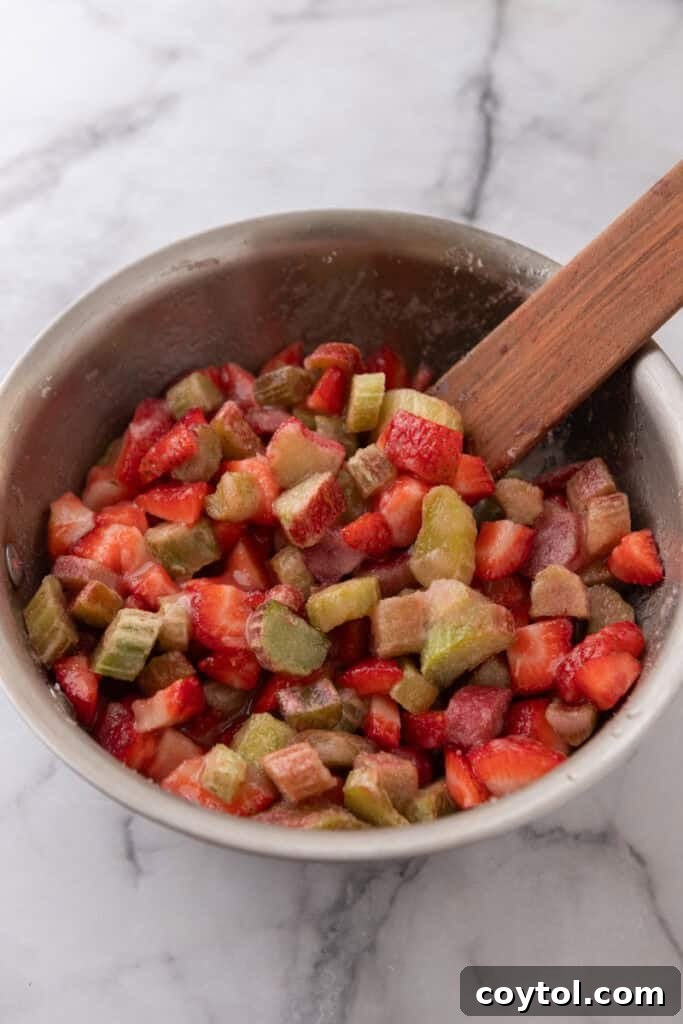 Homemade Strawberry Rhubarb Jam Without Pectin 7 Fruit simmering in a pot, releasing more juices and beginning to thicken.