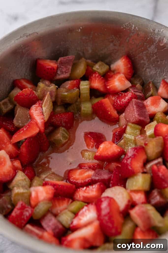 Homemade Strawberry Rhubarb Jam Without Pectin 8 Jam thickening in a pot, showing reduced liquid content.