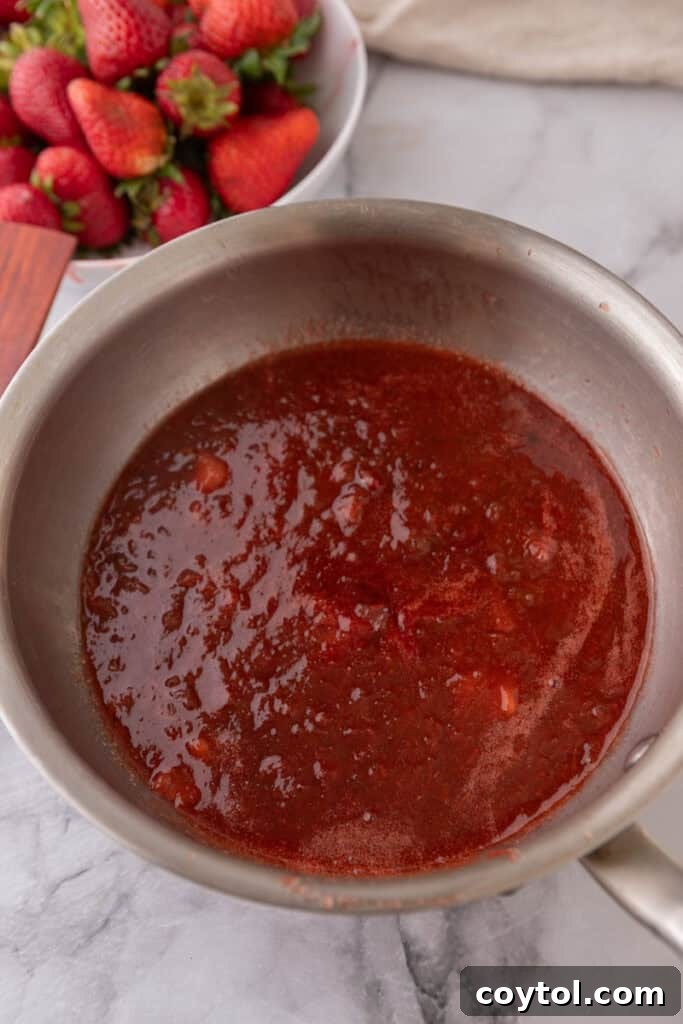 Homemade Strawberry Rhubarb Jam Without Pectin 9 Strawberry rhubarb jam, fully cooked and mashed to desired consistency, in a pot.