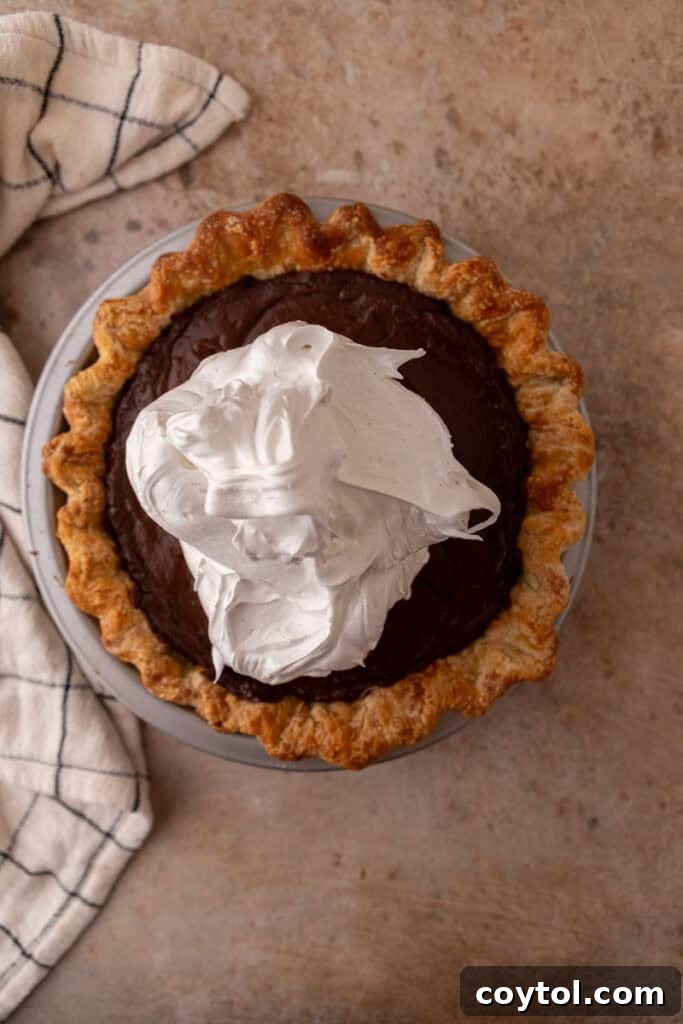 Fluffy Chocolate Meringue Pie Perfection 16 topping being spread onto filling