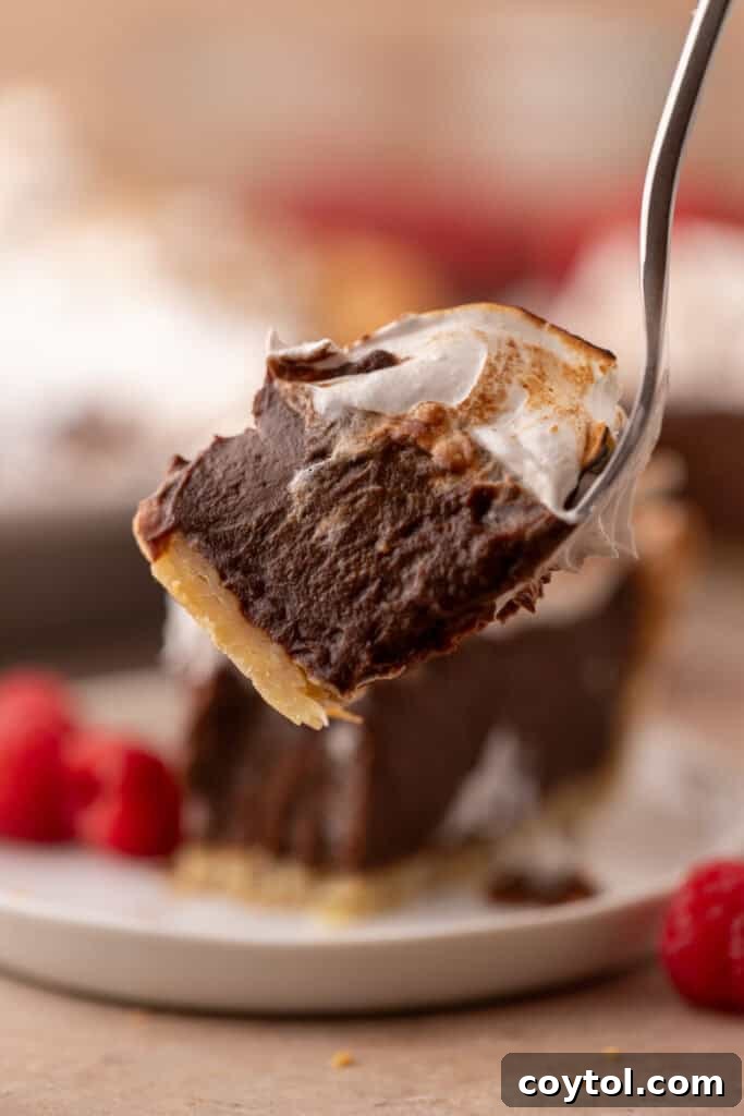 Fluffy Chocolate Meringue Pie Perfection 22 chocolate meringue pie slice recipe with a piece on a fork