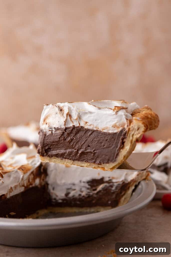 Fluffy Chocolate Meringue Pie Perfection 23 chocolate meringue pie slice on a serving spatula