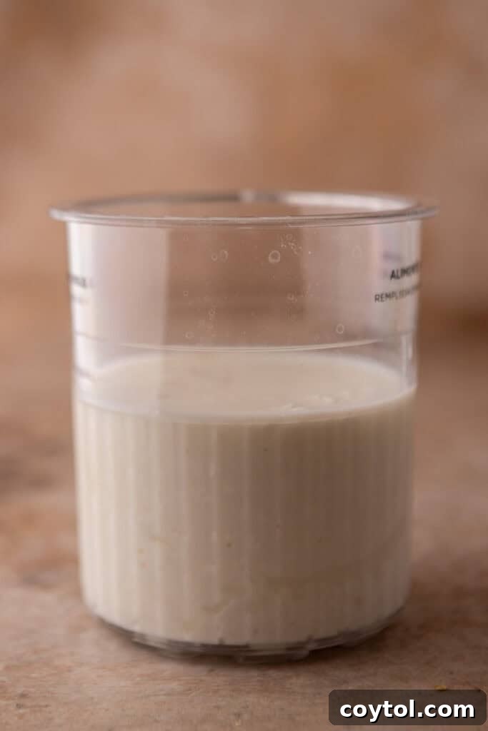 Blended creamy cottage cheese base in Ninja Creami pint before freezing