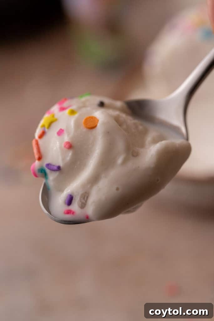 A scoop of high-protein Ninja Creami cottage cheese ice cream being served into a bowl