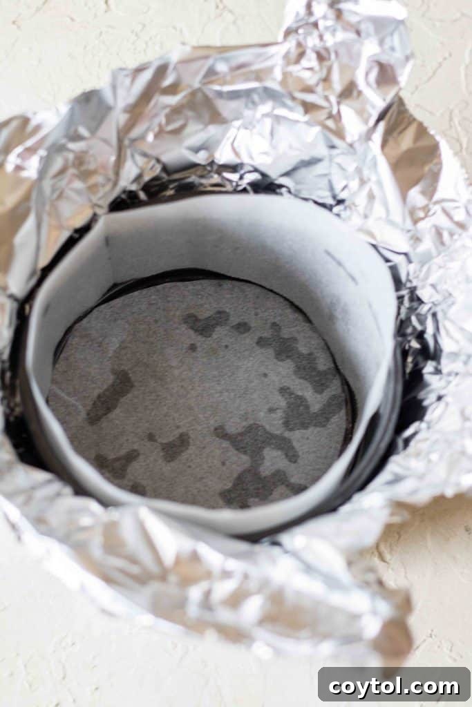 4-inch cheesecake pan wrapped in foil and parchment paper before baking