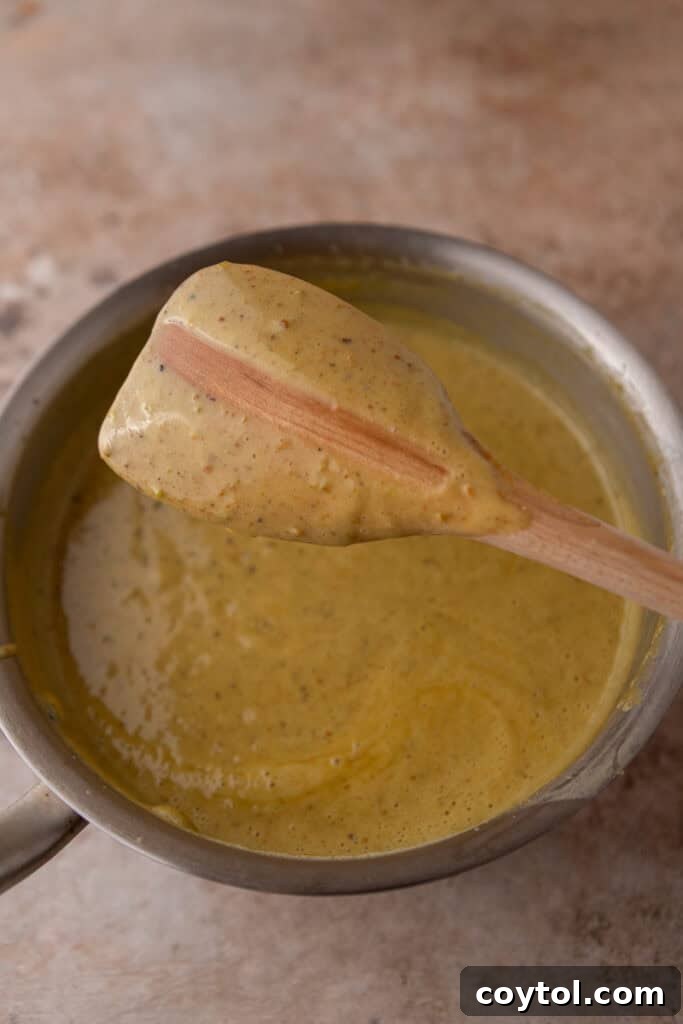 Crafting the Ultimate Homemade Pistachio Ice Cream 12 Strained custard cooling in a bowl