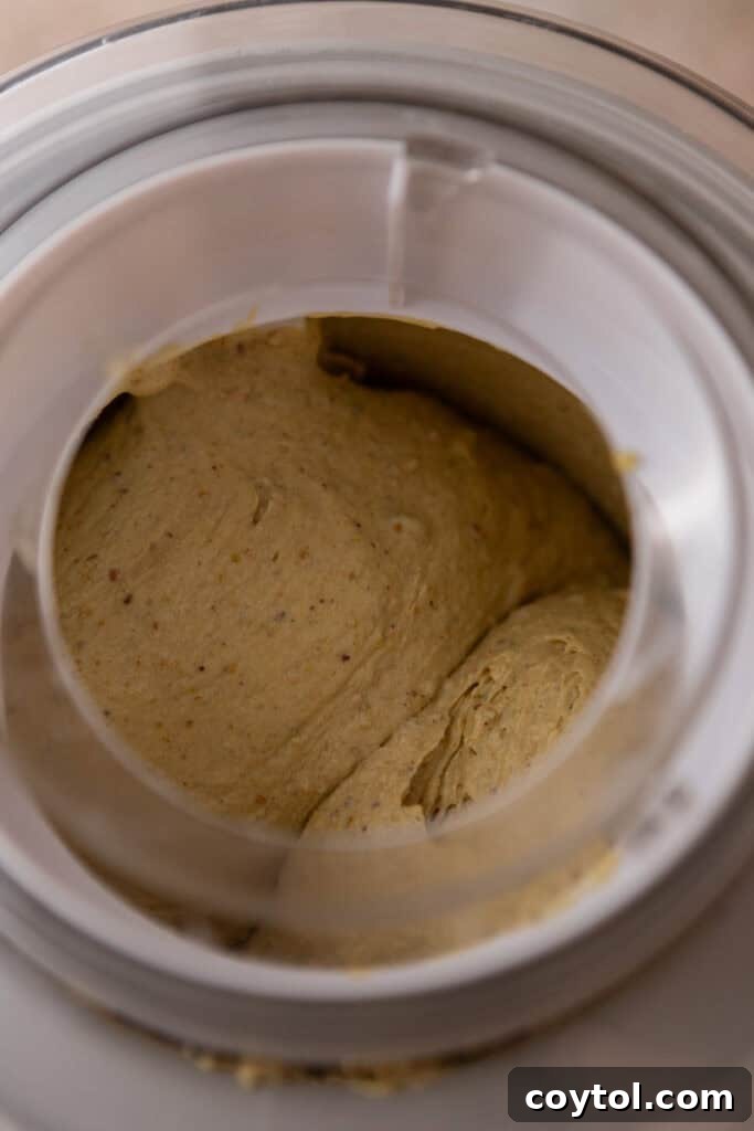 Crafting the Ultimate Homemade Pistachio Ice Cream 13 Pistachio ice cream churning in an ice cream maker