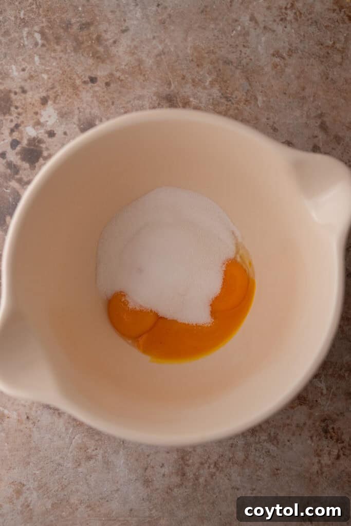 Crafting the Ultimate Homemade Pistachio Ice Cream 8 Egg yolks, sugar, and salt whisked in a bowl