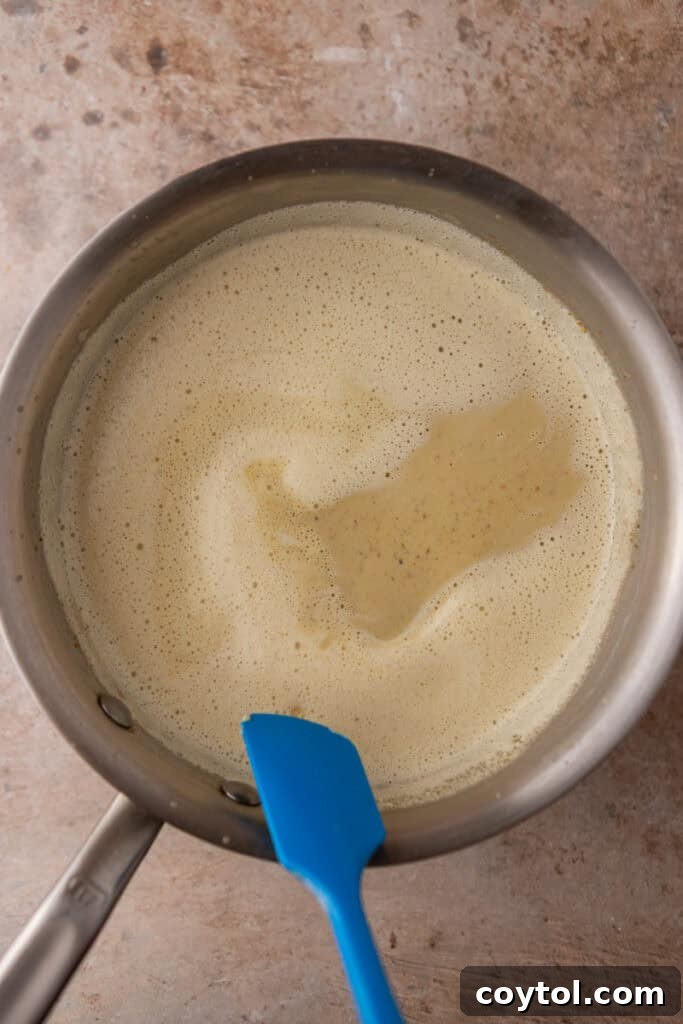 Crafting the Ultimate Homemade Pistachio Ice Cream 10 Tempering egg yolks with hot pistachio mixture