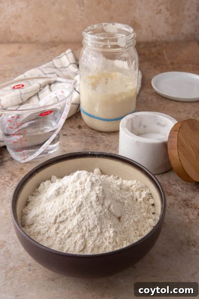 Essential ingredients for same day sourdough bread recipe laid out neatly on a table.