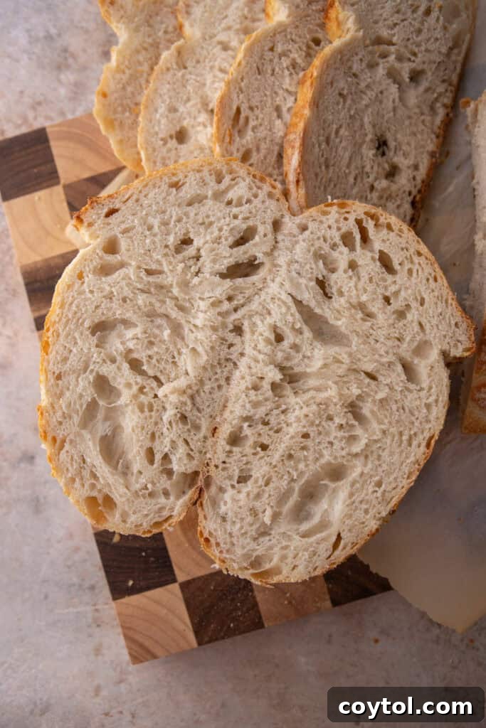 Slices of freshly baked same day sourdough bread, revealing its open and airy crumb structure.