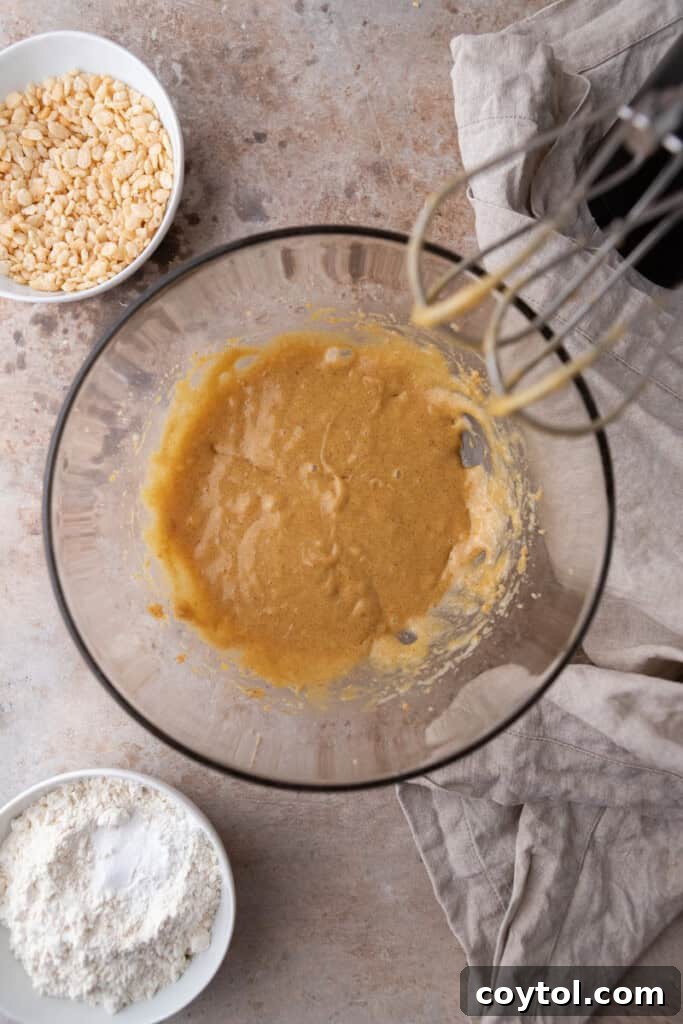 The fully combined wet ingredients in a mixing bowl, smooth and ready for dry additions.