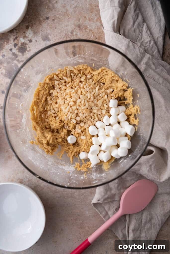 Cookie dough with Rice Krispies and marshmallows folded in, ready for chilling.