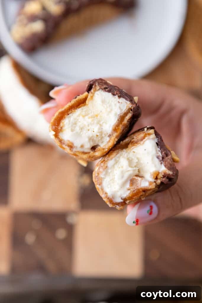Ultimate Stroopwafel Choco Tacos Caramel Chocolate Perfection 2 Stroopwafel Choco Tacos split in half, revealing creamy ice cream filling and caramel swirl.