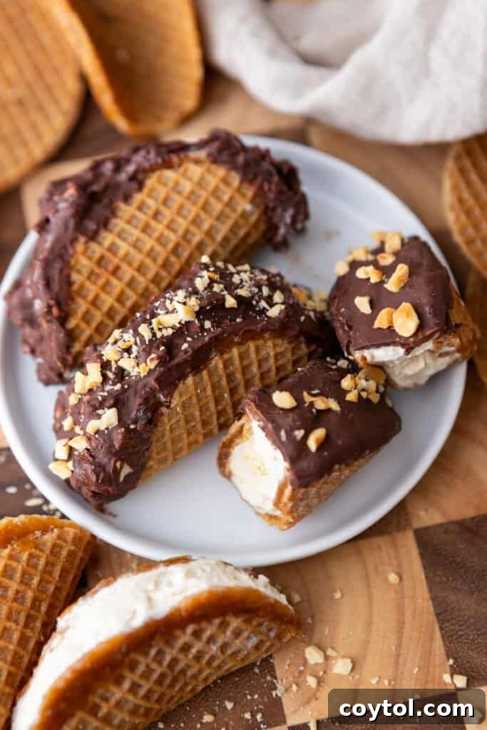 Ultimate Stroopwafel Choco Tacos Caramel Chocolate Perfection 11 Two Stroopwafel Choco Tacos on a small white plate, ready to be enjoyed.