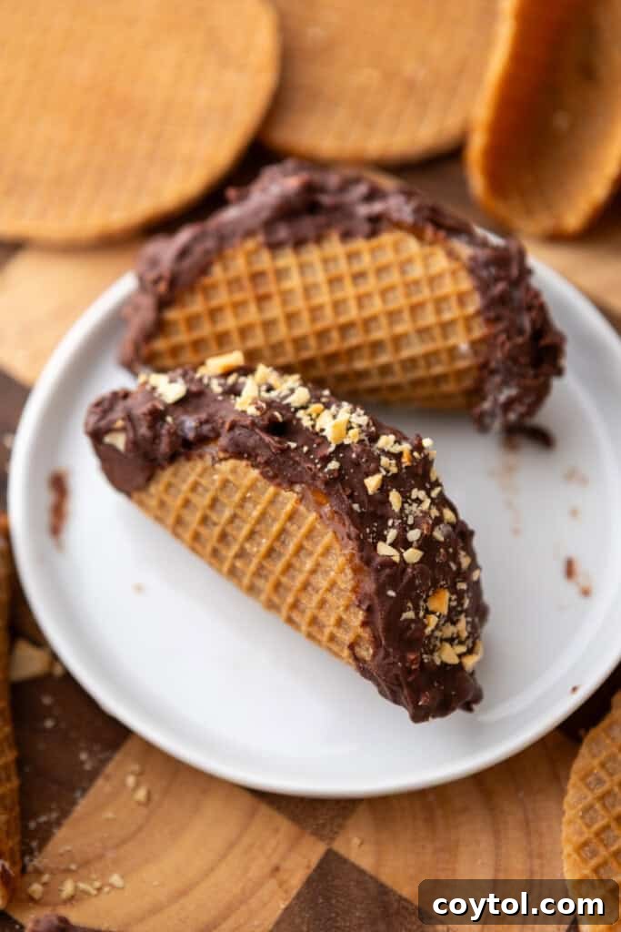Ultimate Stroopwafel Choco Tacos Caramel Chocolate Perfection 12 Three perfectly crafted Stroopwafel Choco Tacos on a white plate, showcasing a delightful dessert.