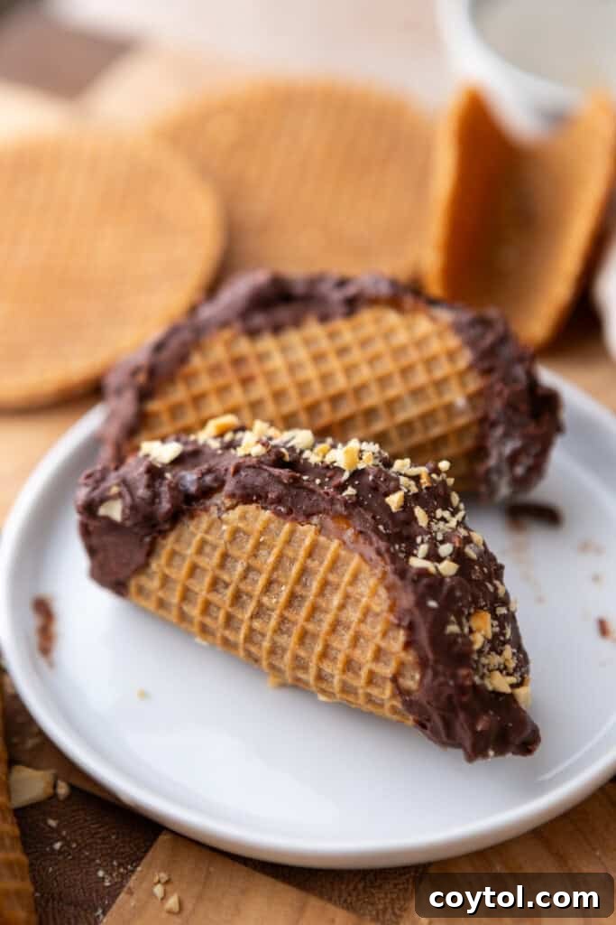 Ultimate Stroopwafel Choco Tacos Caramel Chocolate Perfection 4 Three Stroopwafel Choco Tacos artfully arranged on a white plate, showcasing their chocolate and peanut topping.
