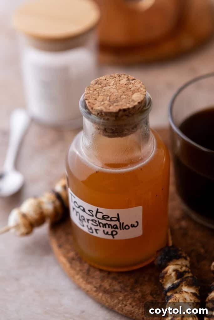 Homemade toasted marshmallow syrup going in a jar