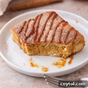 A close-up shot of a churro pumpkin cheesecake bar with a small corner missing, showcasing the delicious layers and texture.
