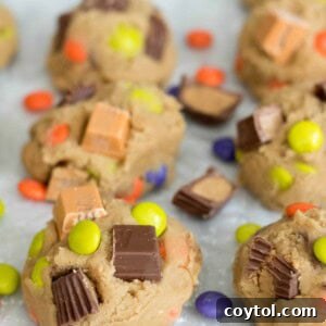 Cookie dough with colorful chocolate and candy for leftover Halloween candy cookies
