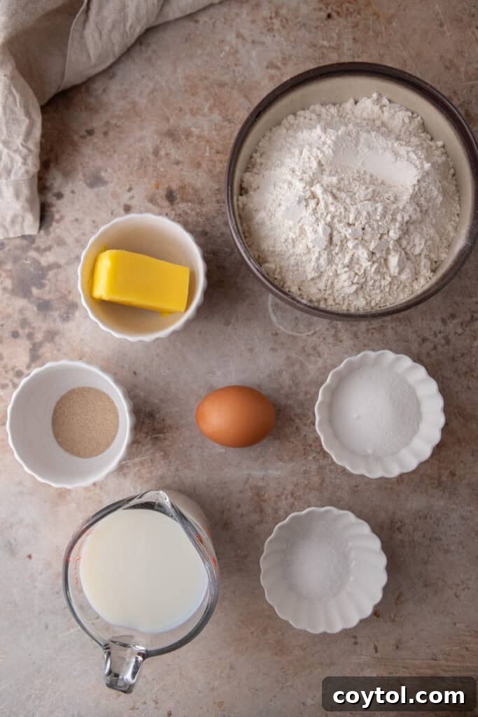 Pillowy Soft Buttery Holiday Rolls 3 Fresh ingredients for homemade dinner rolls laid out on a clean kitchen counter, ready for baking