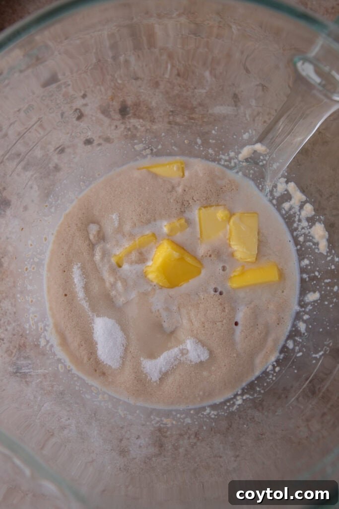 Pillowy Soft Buttery Holiday Rolls 6 Wet ingredients for dinner rolls fully combined in a large mixing bowl, ready for dry ingredients