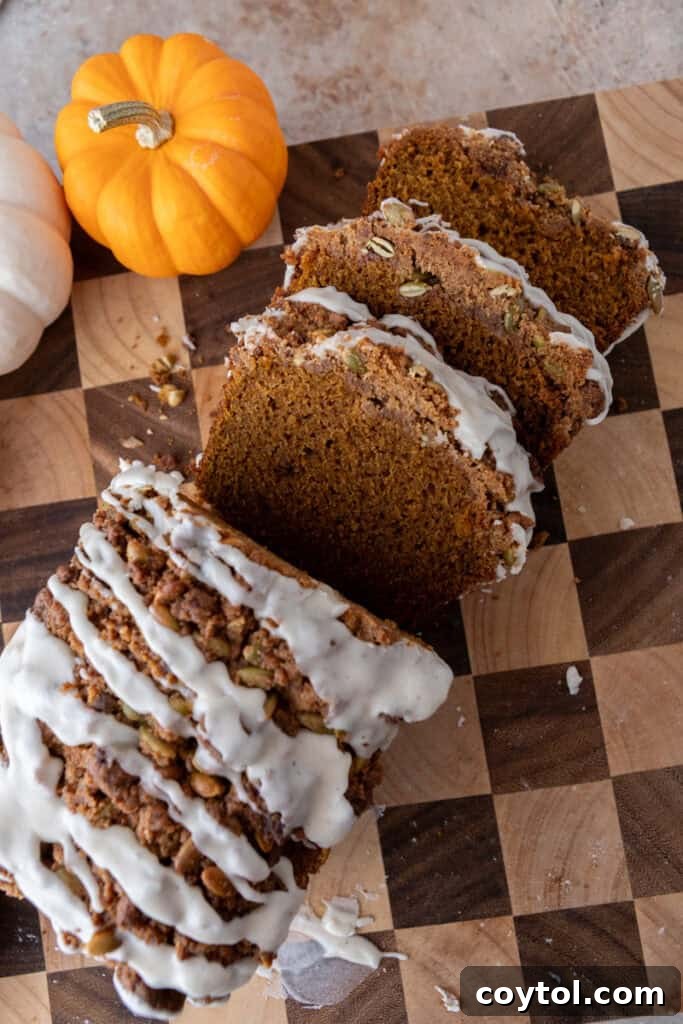 A freshly baked Streusel Pumpkin Bread, cut into several slices, revealing its perfect interior.