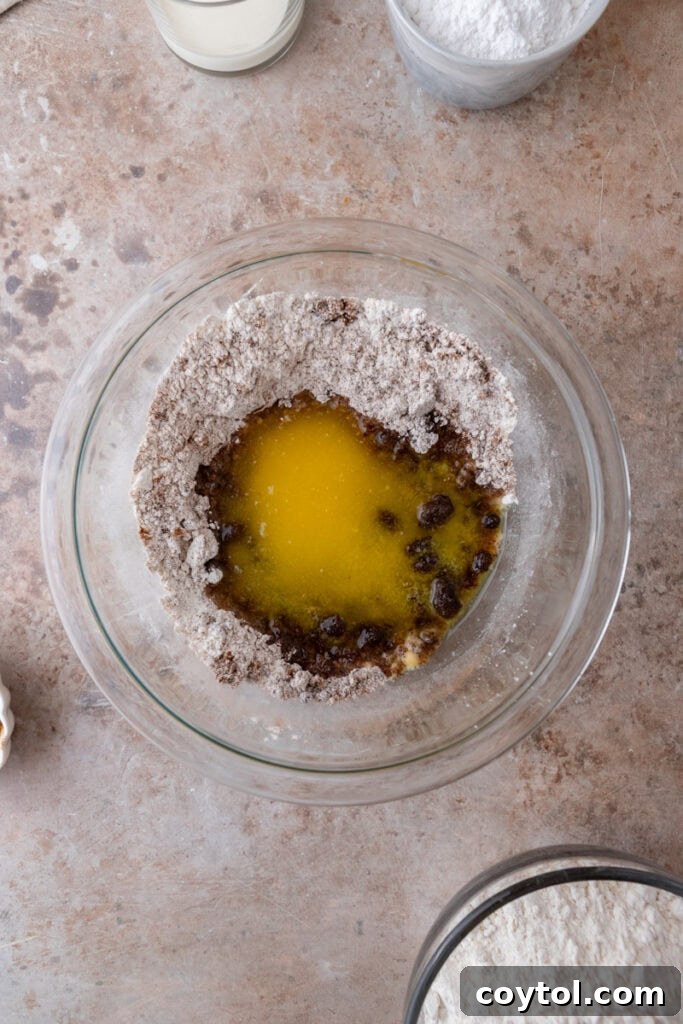 Melted butter being added to streusel ingredients.