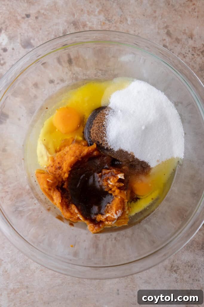 Wet ingredients for pumpkin bread whisked in a bowl.