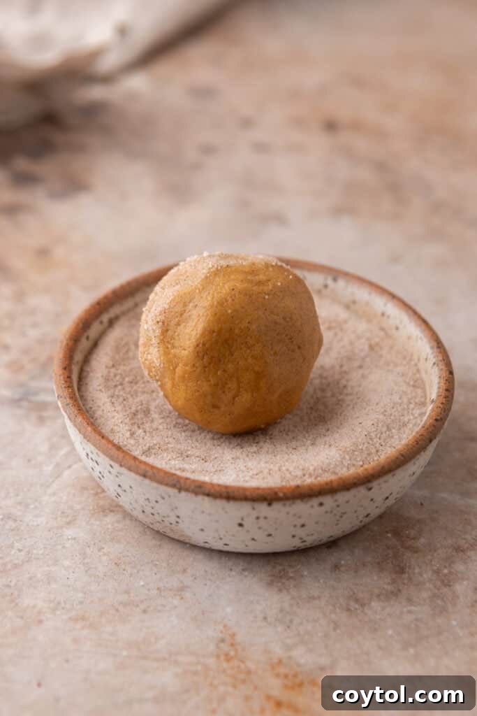 raw dough getting rolled in sugar