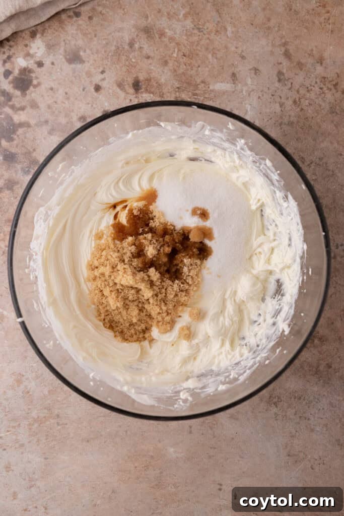 Irresistible Pecan Pie Cheesecake Bites 14 Sugar, salt, and vanilla extract added to the cream cheese mixture, ready to be combined.