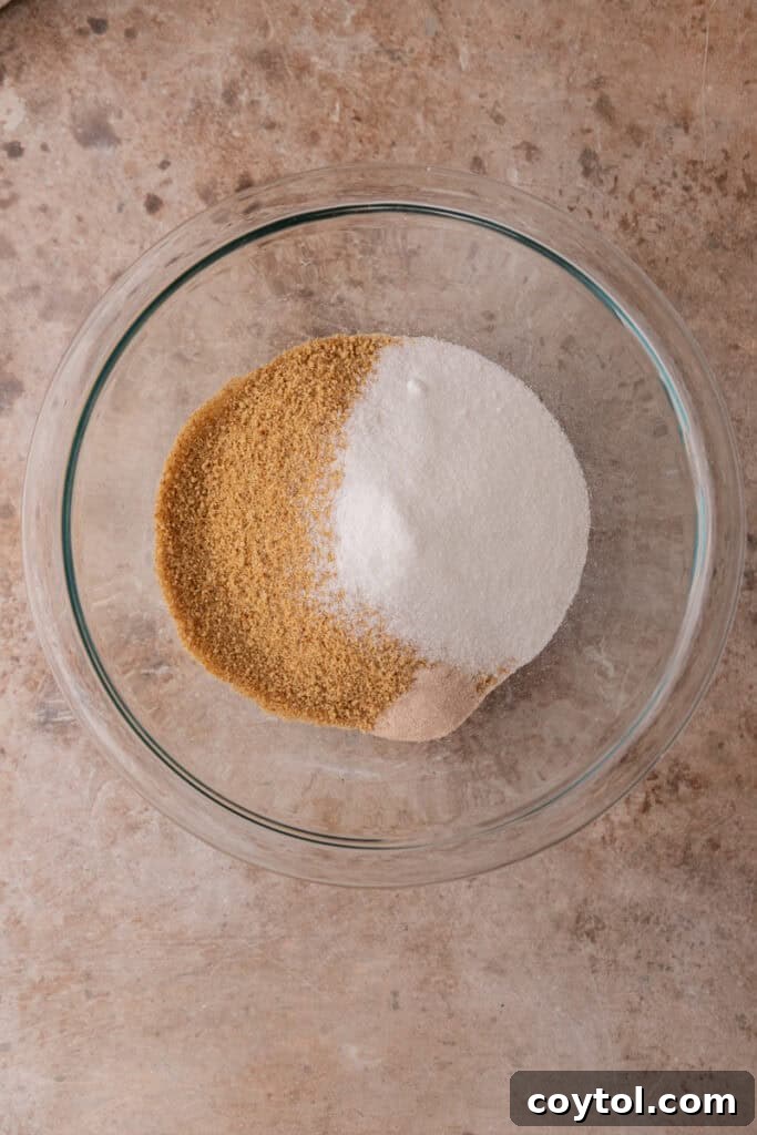 Irresistible Pecan Pie Cheesecake Bites 7 Crust ingredients: graham cracker crumbs, sugar, salt, and melted butter, mixed in a bowl.