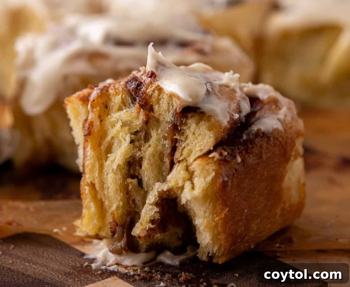 Soft brioche cinnamon roll with gooey cinnamon filling and cream cheese icing
