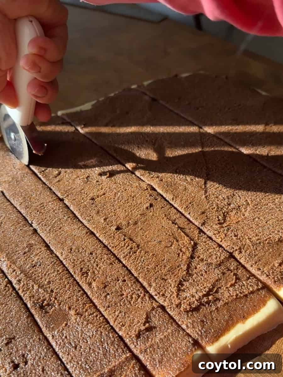 Spreading cinnamon filling over rolled brioche dough