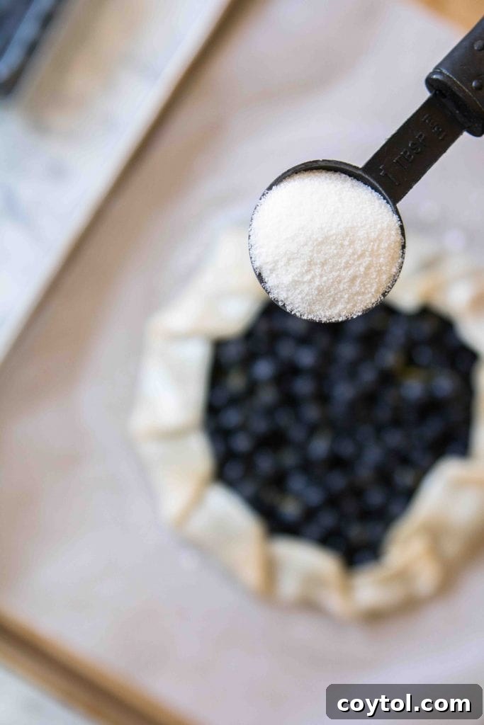 Brushing the galette crust with heavy cream