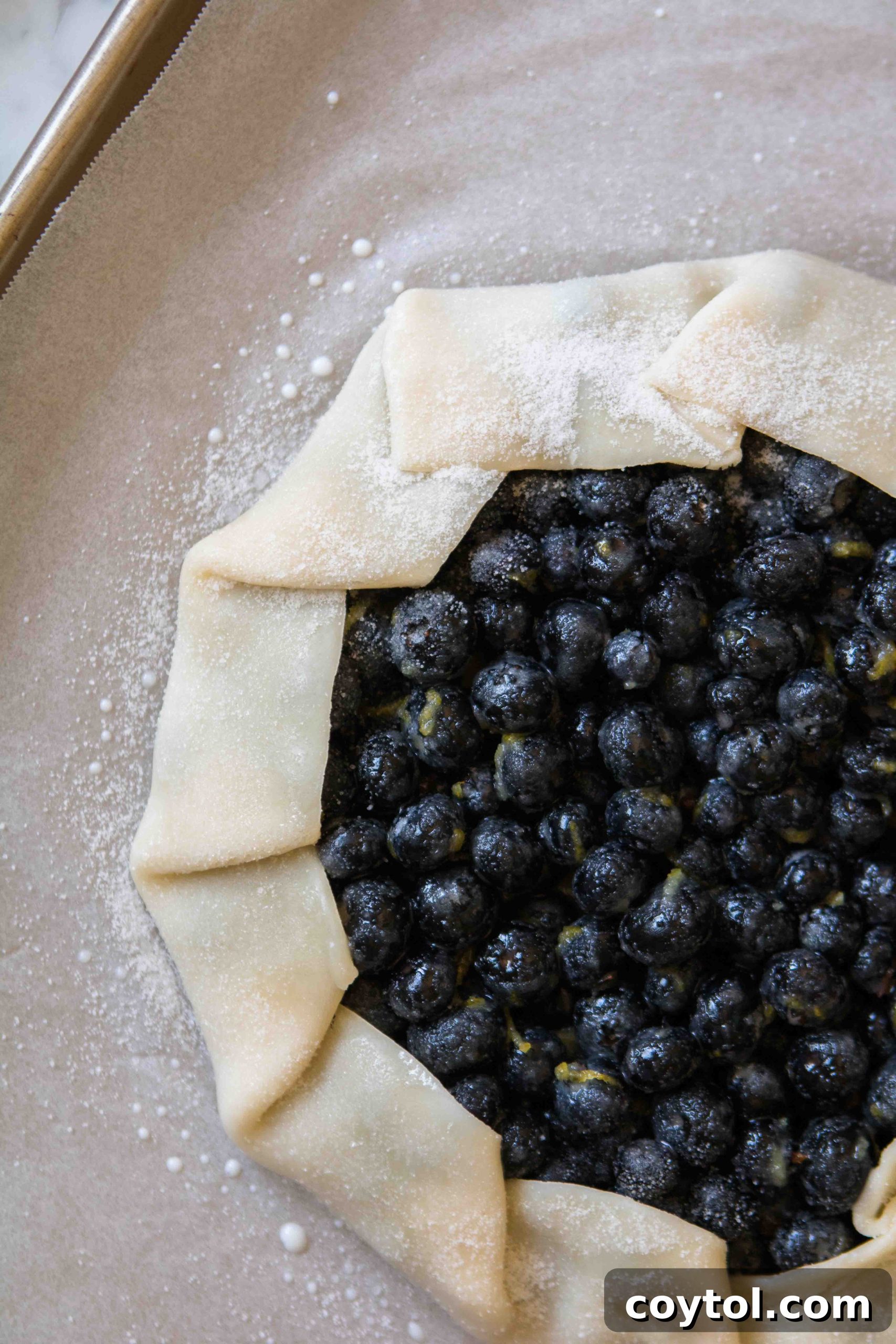 Sprinkling sugar on the galette crust before baking