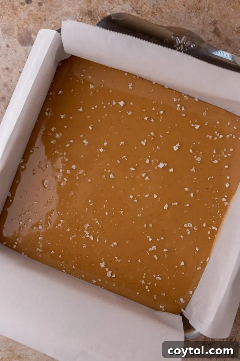 Warm caramel poured into an 8x8 pan and topped with sea salt