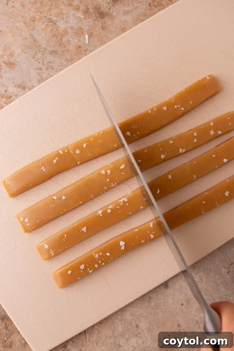 Cutting cooled caramel slab into strips using a sharp knife