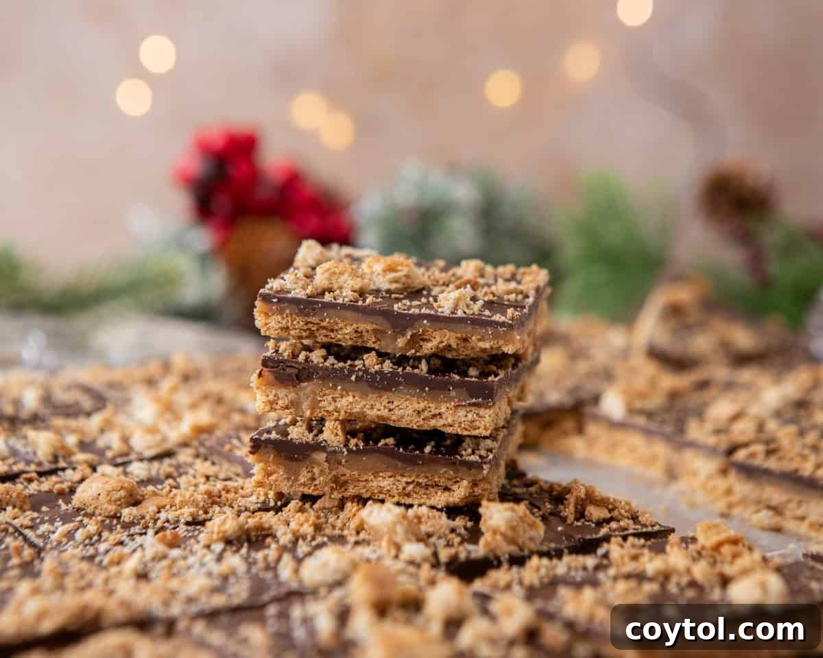 Graham cracker Christmas crack stacked in layers with chocolate and toffee